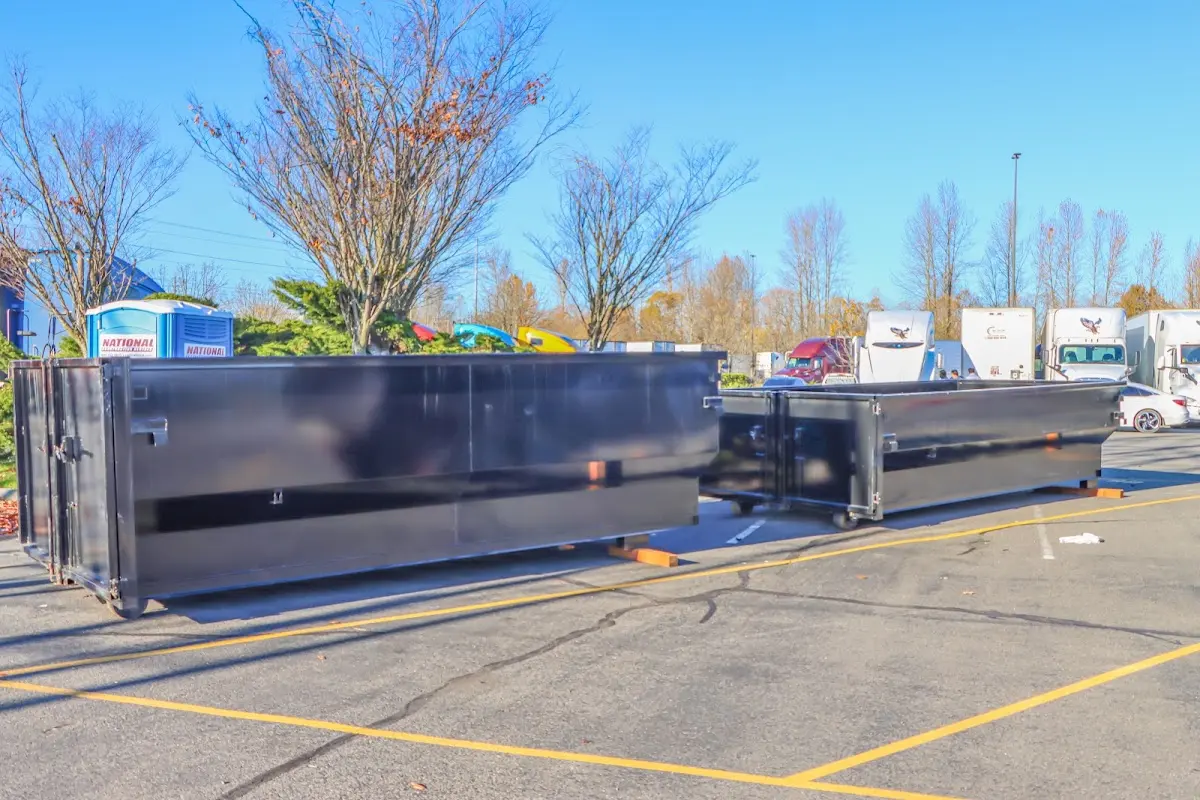 Professional dumpster rental service with roll-off container on residential driveway in Brattleboro
